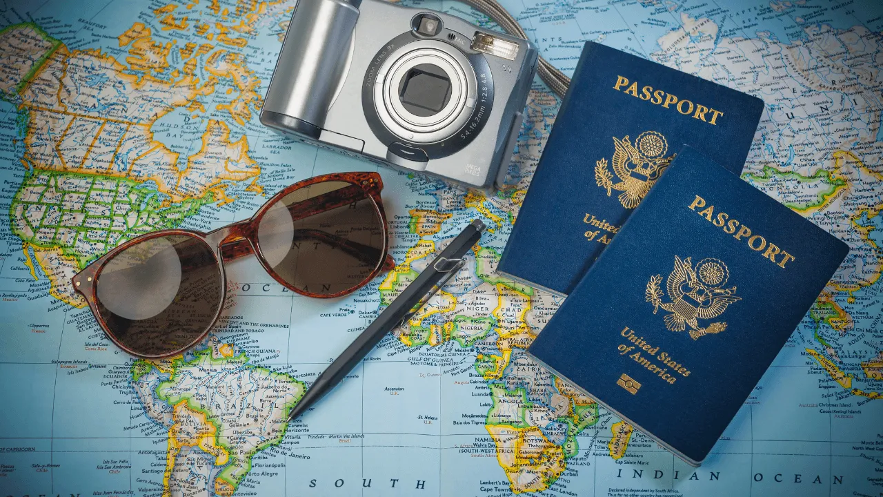 Passport, sunglasses, camera, travel