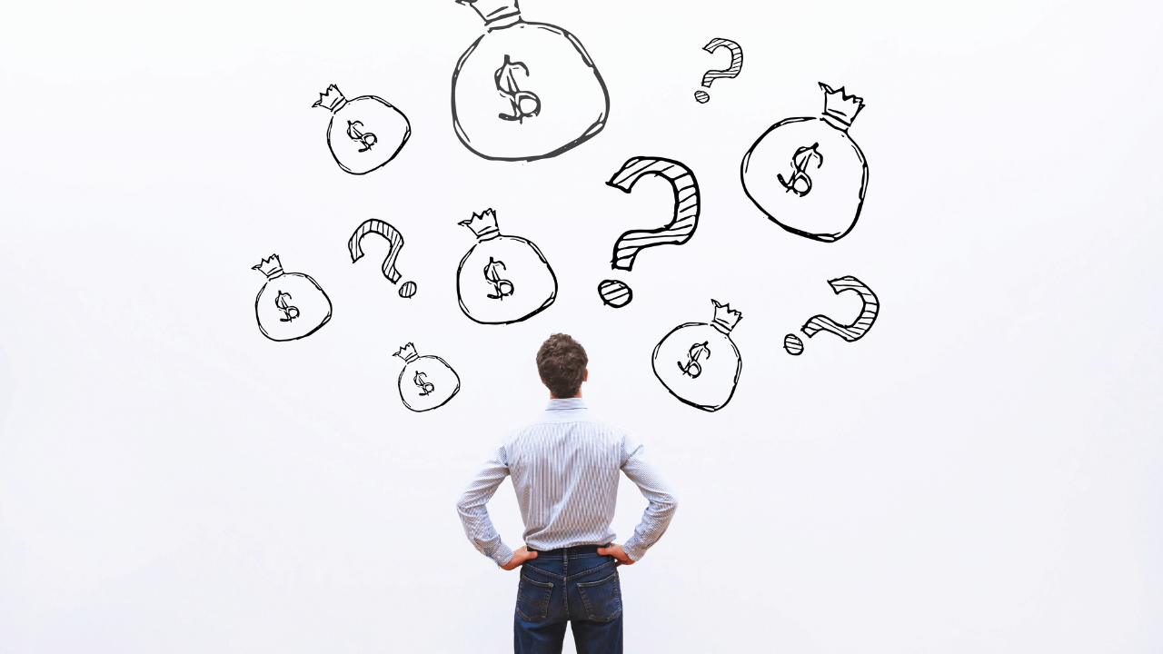 man looking at bags of money in confusion