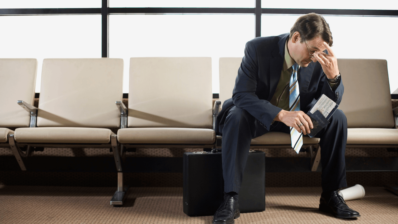 sulking business man at the airport