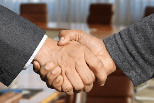 Two business partners shaking hands | Scott Legal, P.C. Two business partners shaking hands