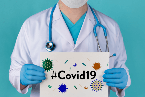 Doctor holding a Covid-19 Sign