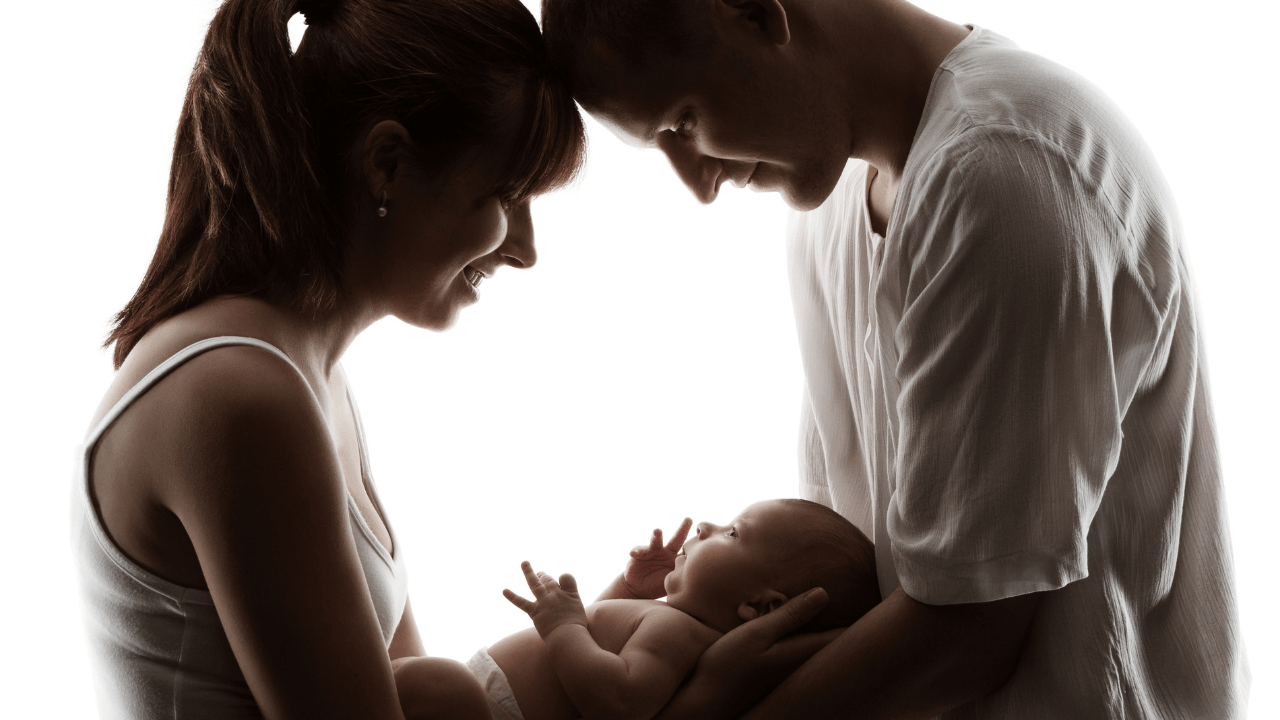 Man and woman holding newborn baby