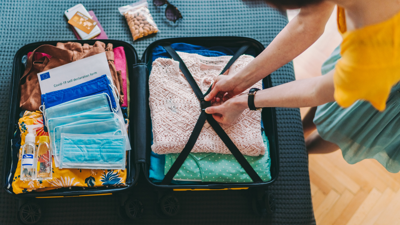 woman packing travel luggage covid masks included