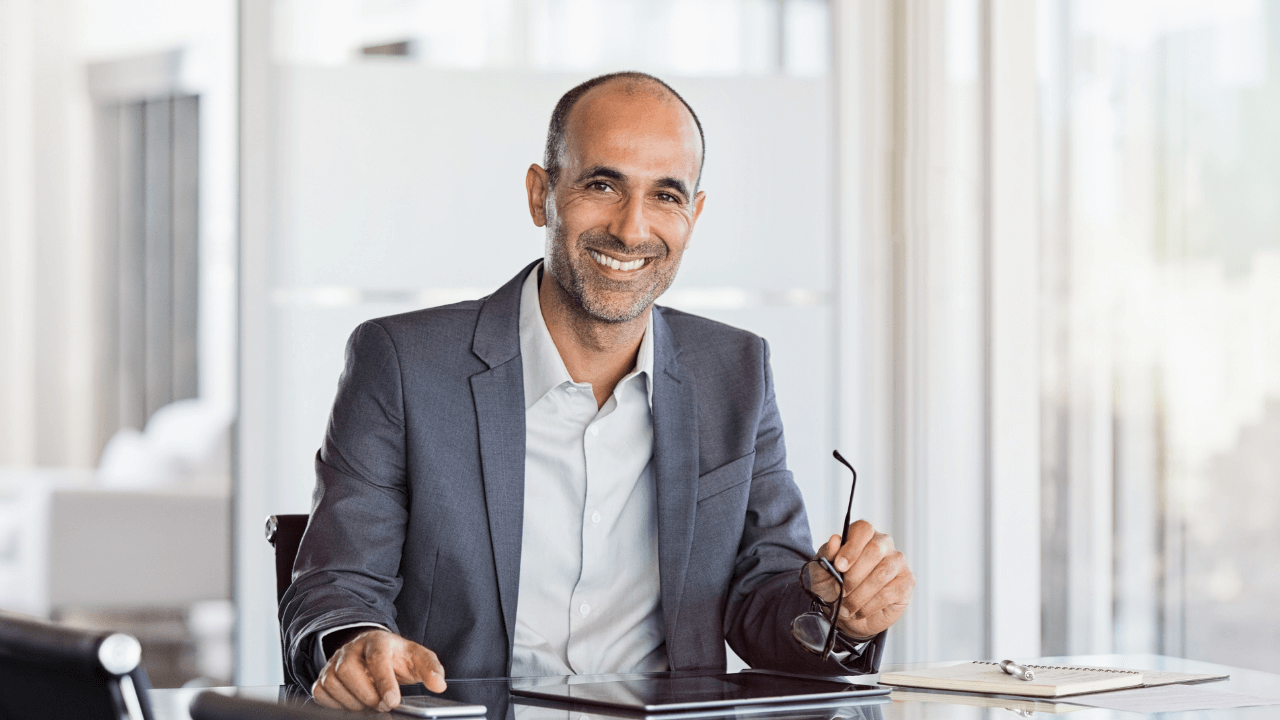 Business man smiling while sitting in his office