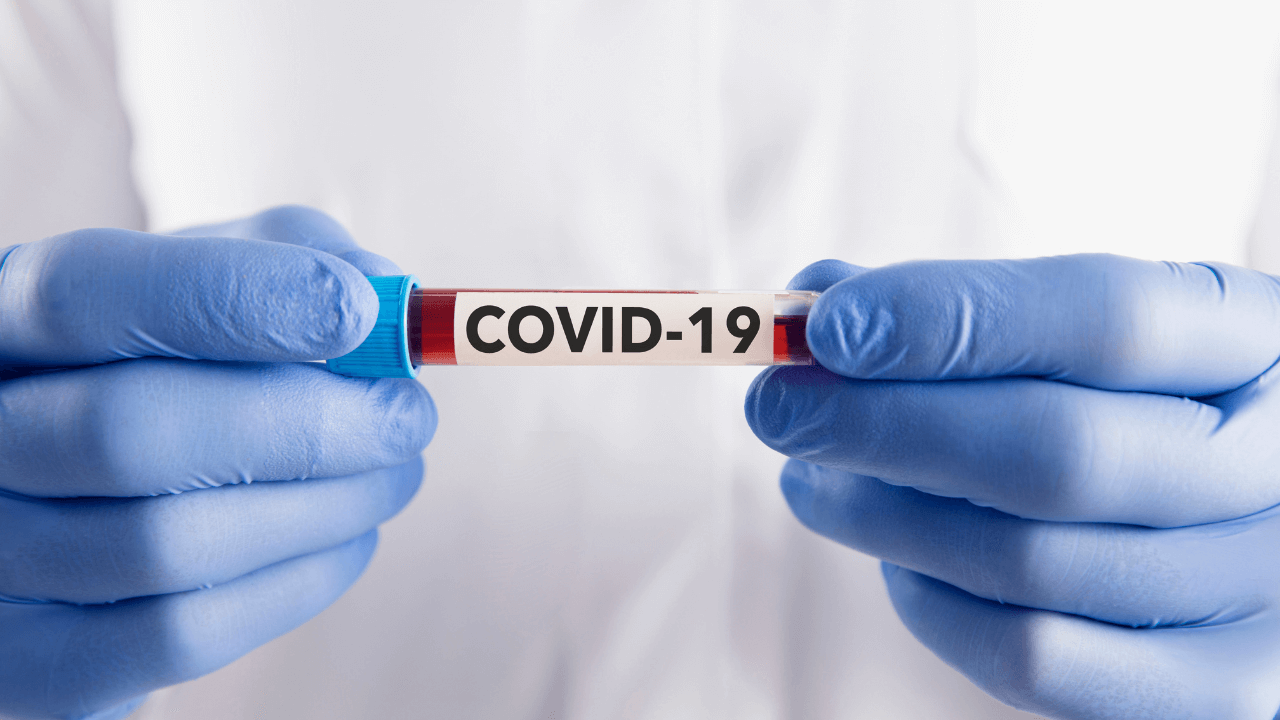 Doctor holding covid 19 vial