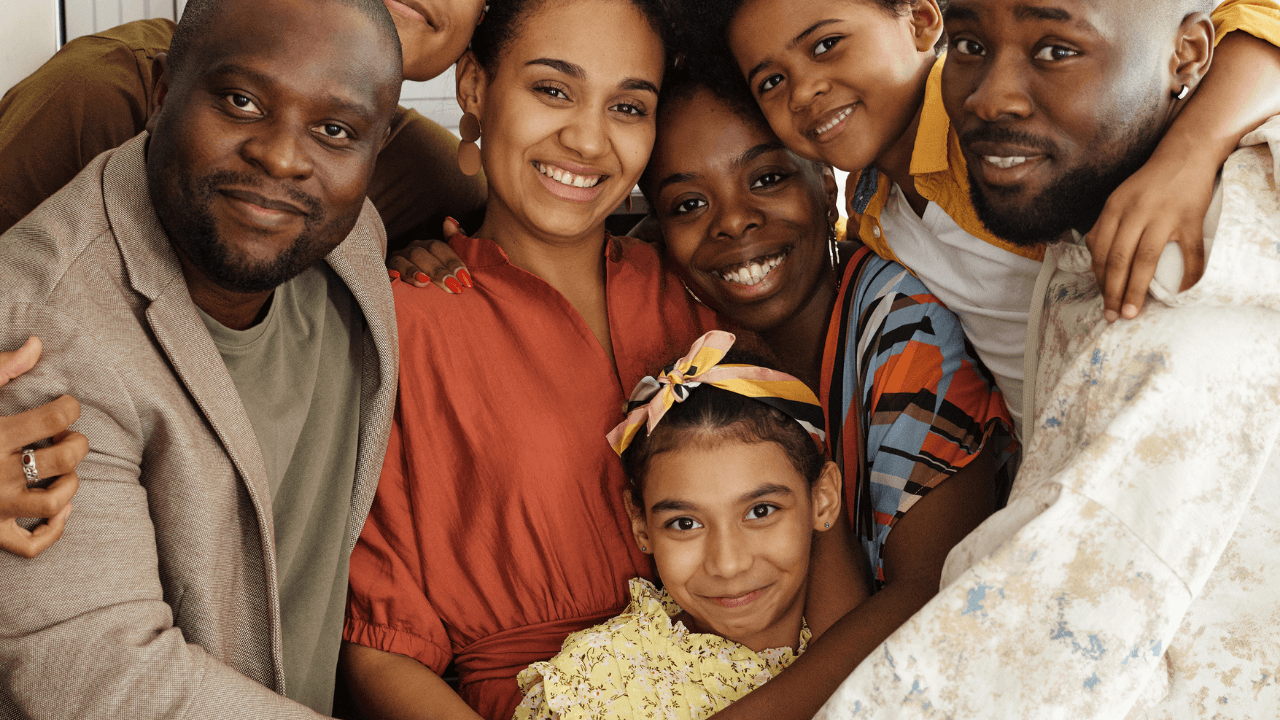 A family of 7 embracing each other while smiling