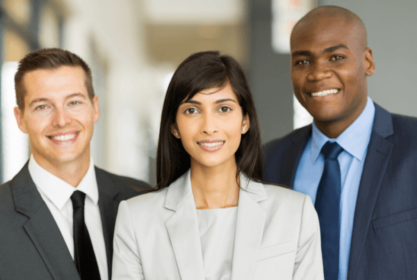 3 entrepreneurs smiling in their business attire