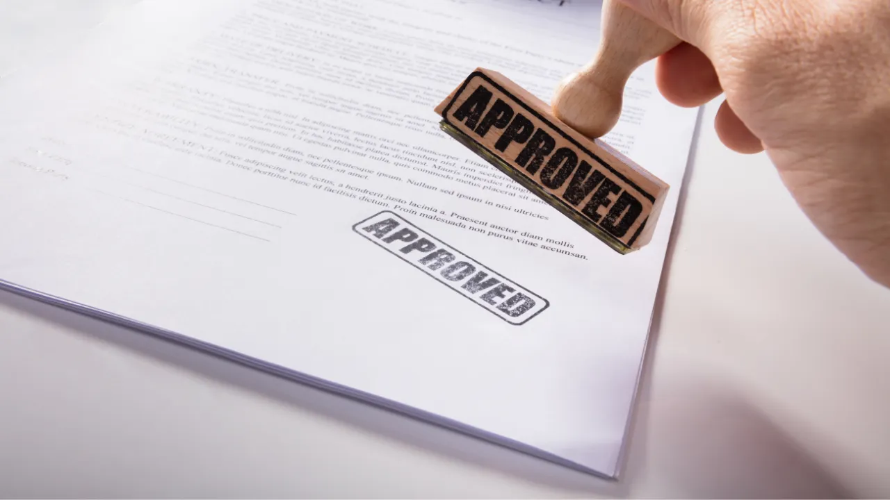 Approved stamp on a white piece of paper