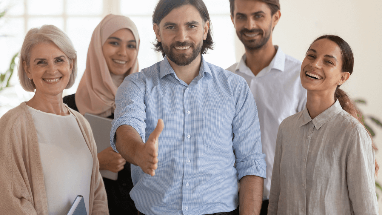 An office team welcoming a new person