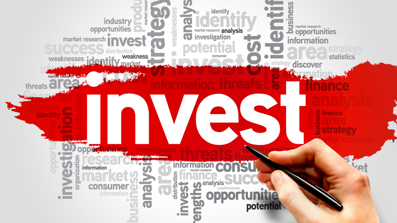 the word invest highlighted in red on a piece of paper