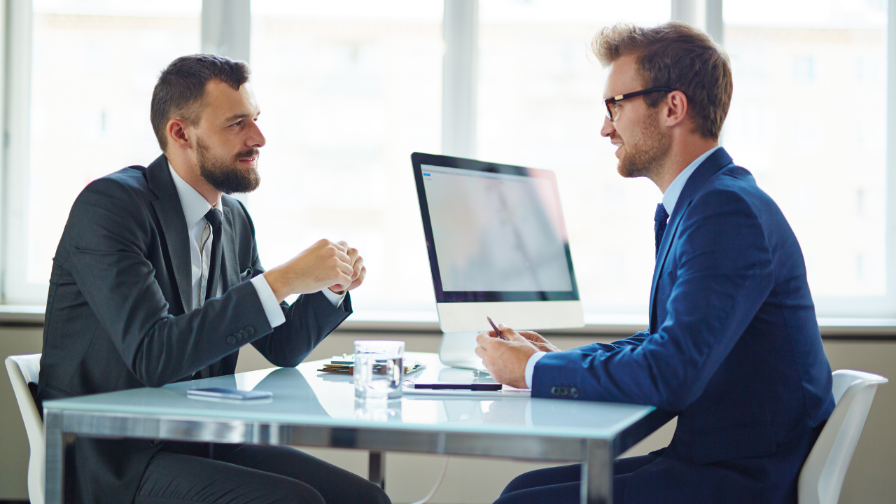 Two business men speaking in their office