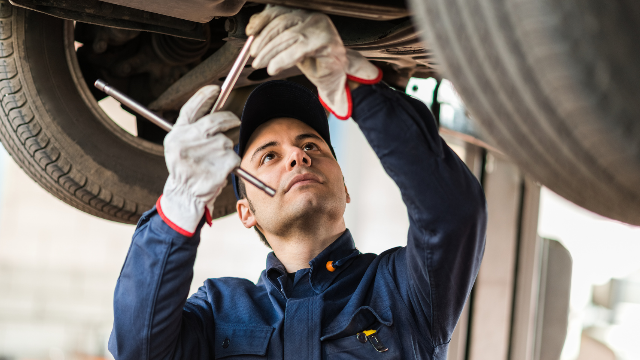 a car mechanic working under a car