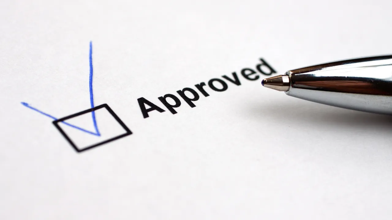 Approved checked on paper in blue pen