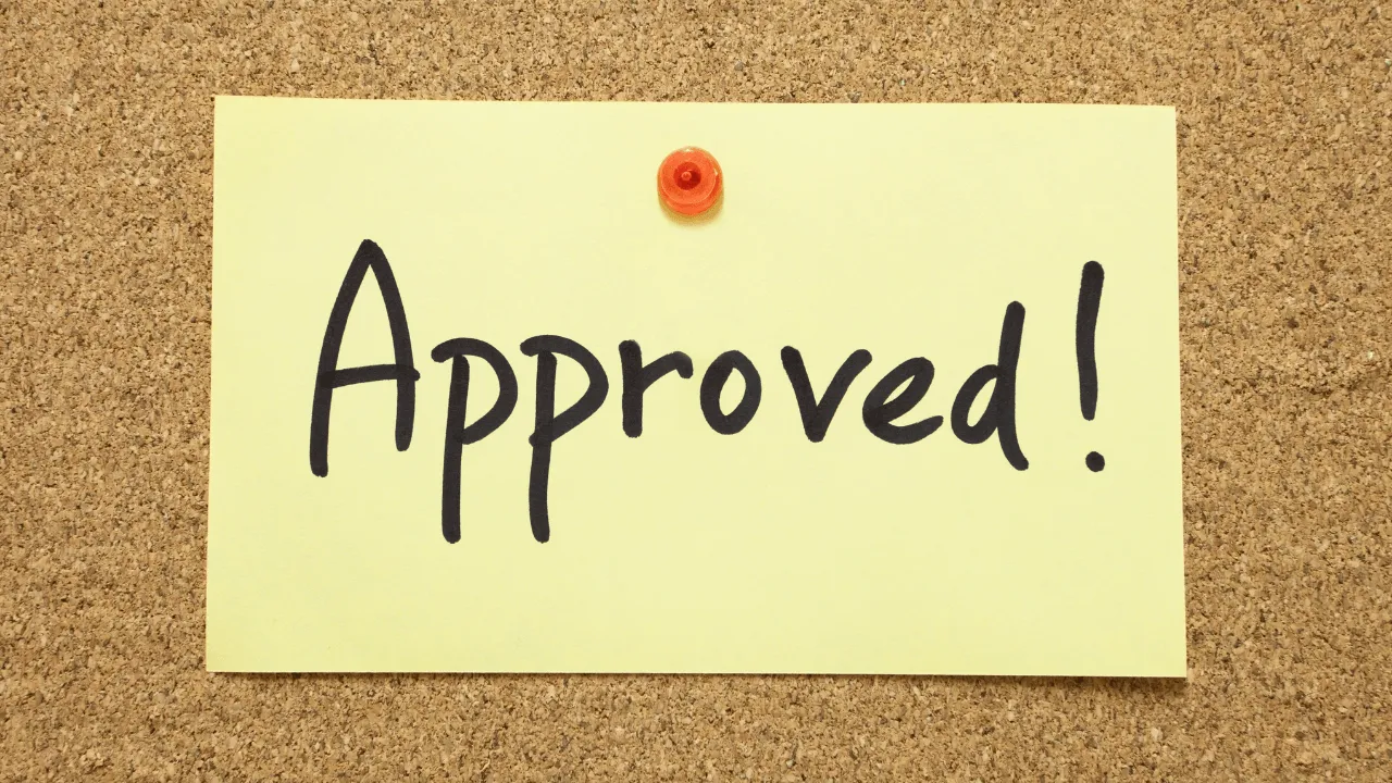 Approved post it on a cork board