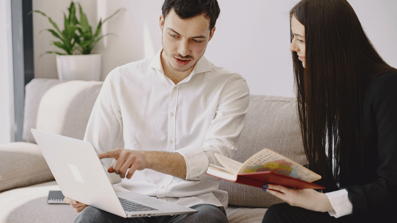 A man and a woman working together on a laptop