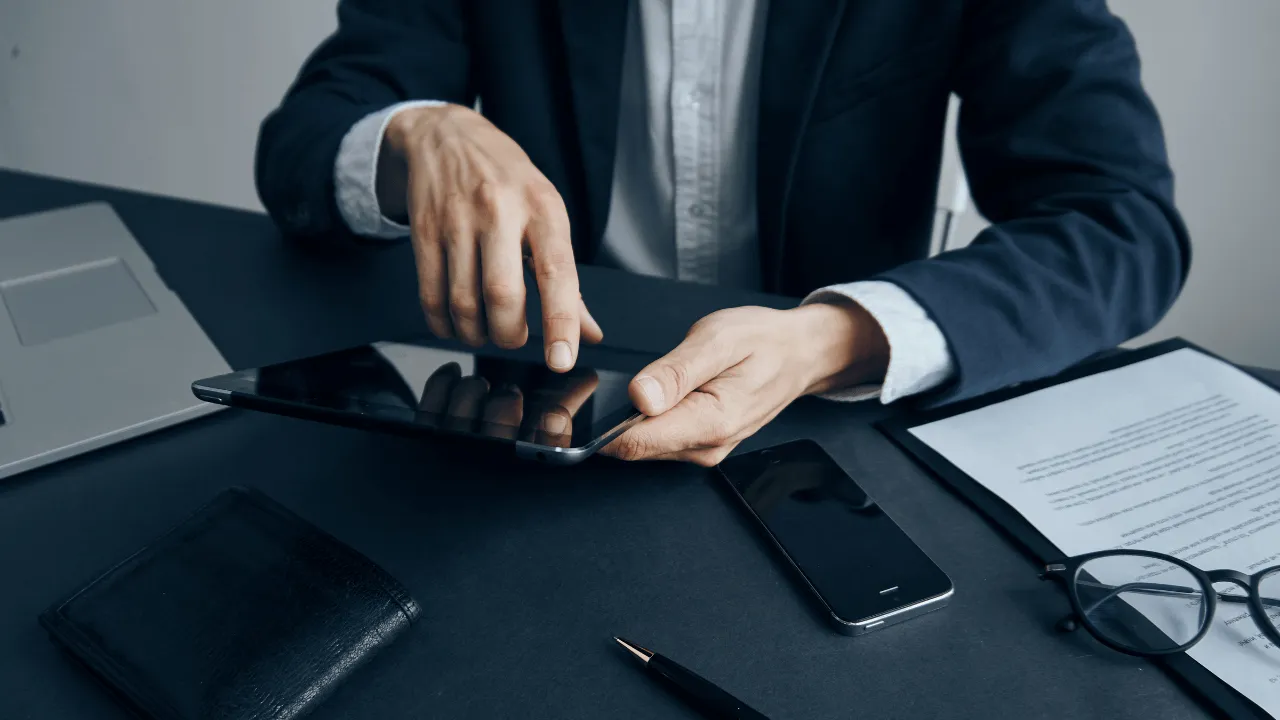 A business man working on his tablet at his desk