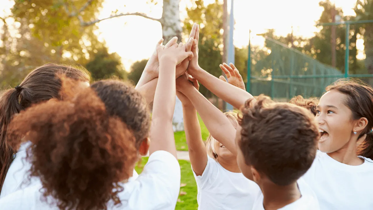 a group of youth high fiving each other