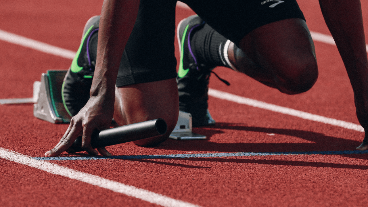 a track and field runner with a baton