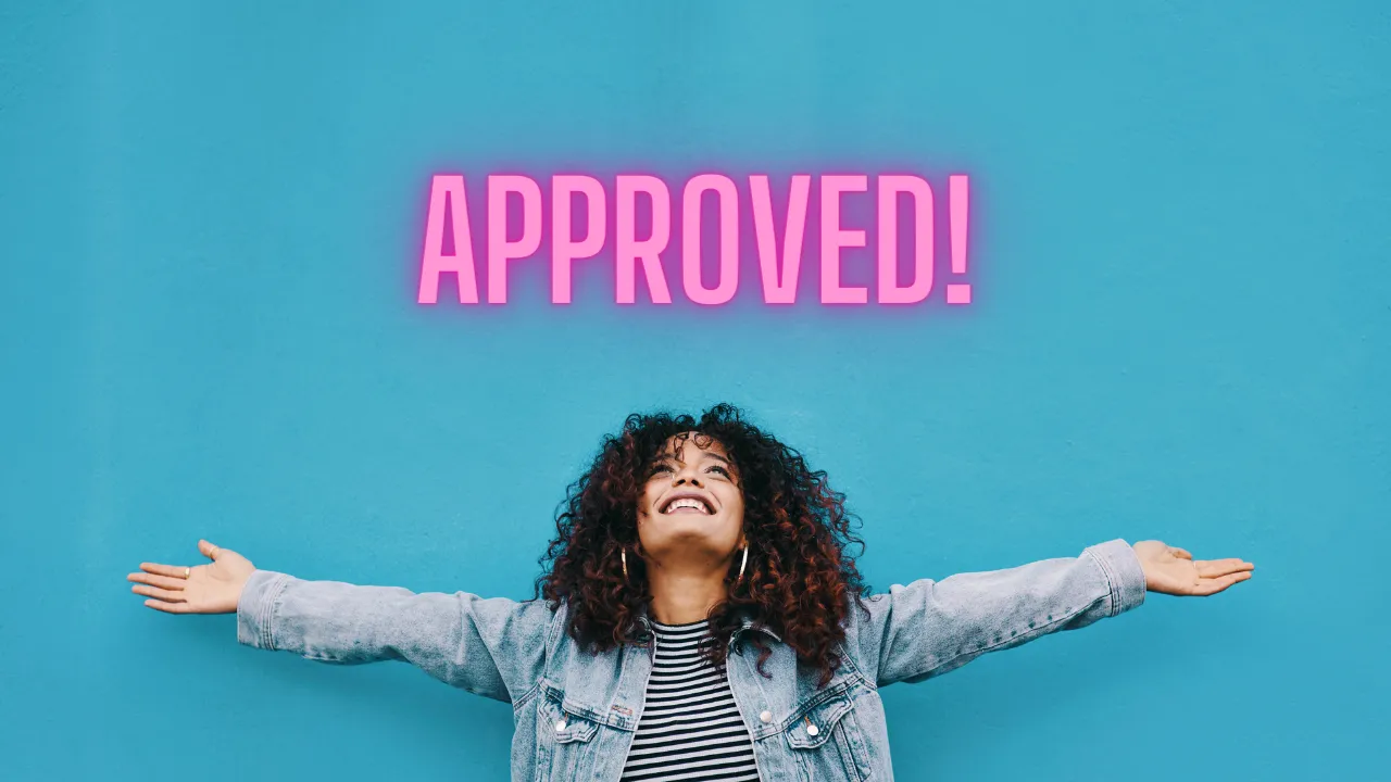 A woman happily looking up at "approved"