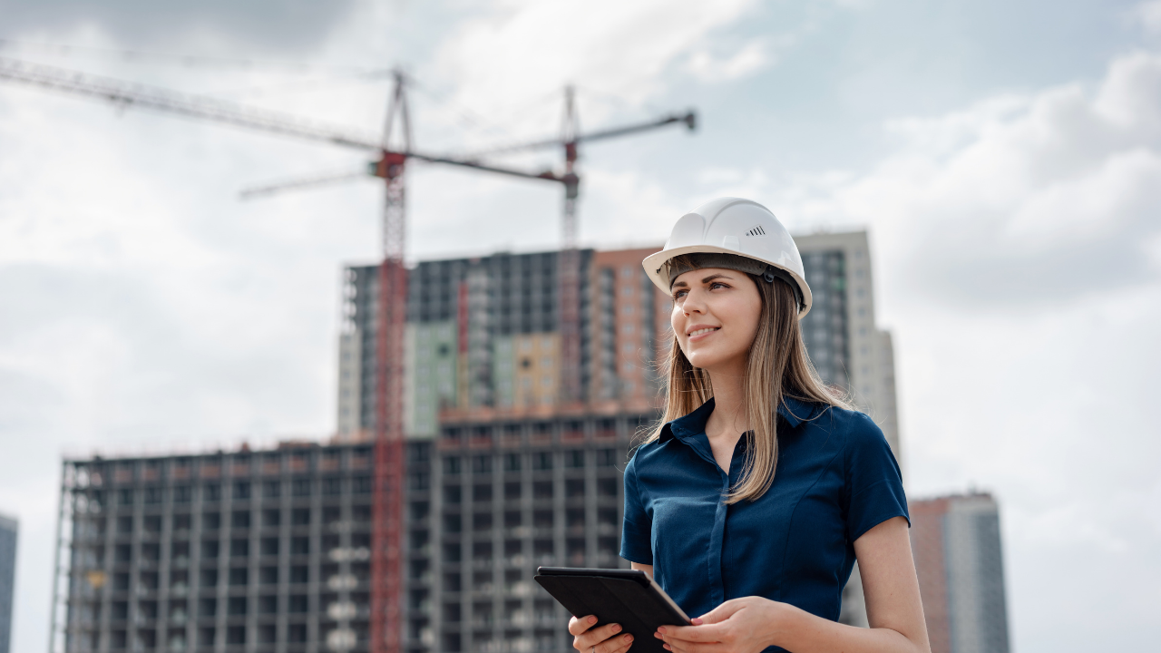 An engineer holding a clipboard while on a construction site