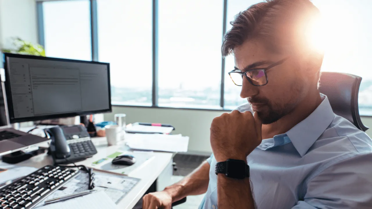 A man doing work on his computer in his office