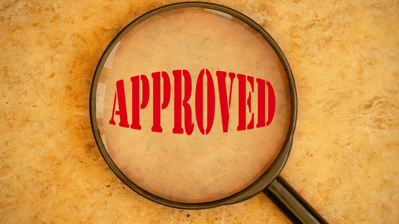 Approved being seen through a magnifier glass