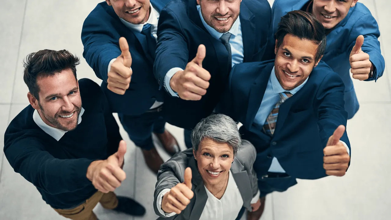 An office team giving a thumbs up at at an approval