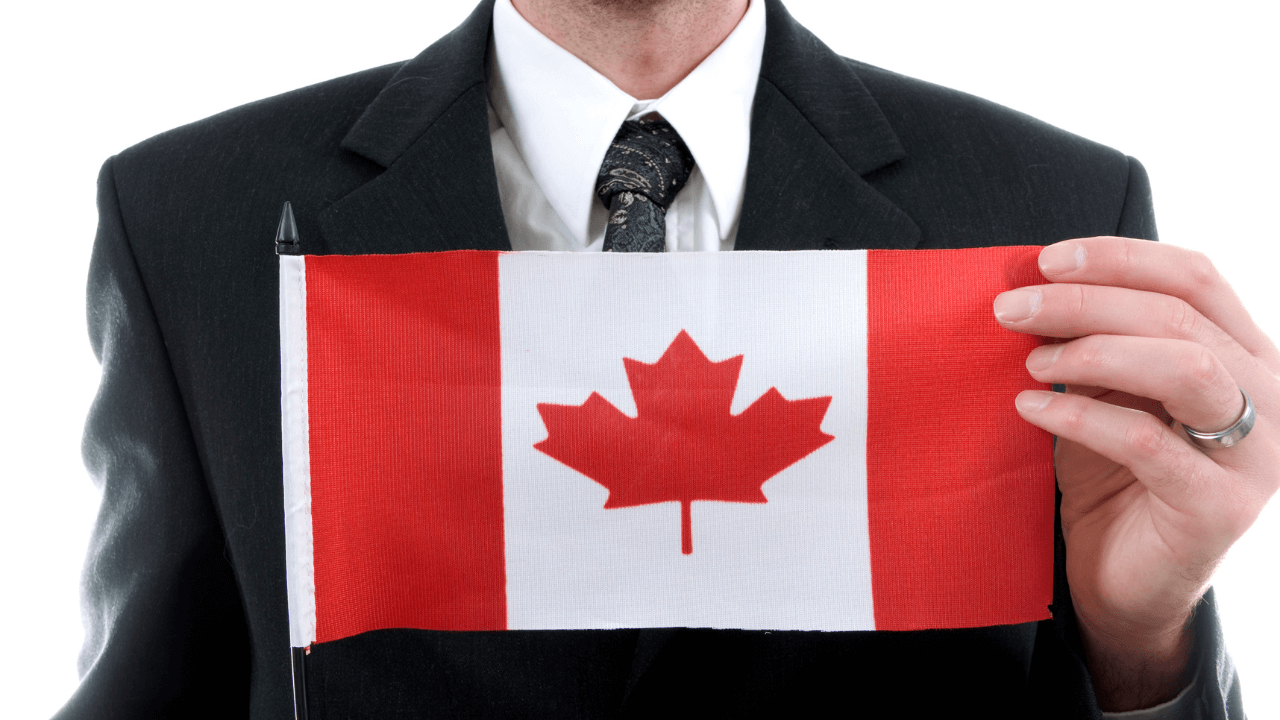 A business owner holding a Canadian flag