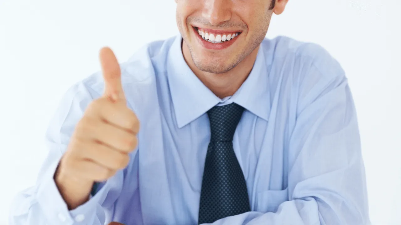 A man showing a thumbs up in response to an approval