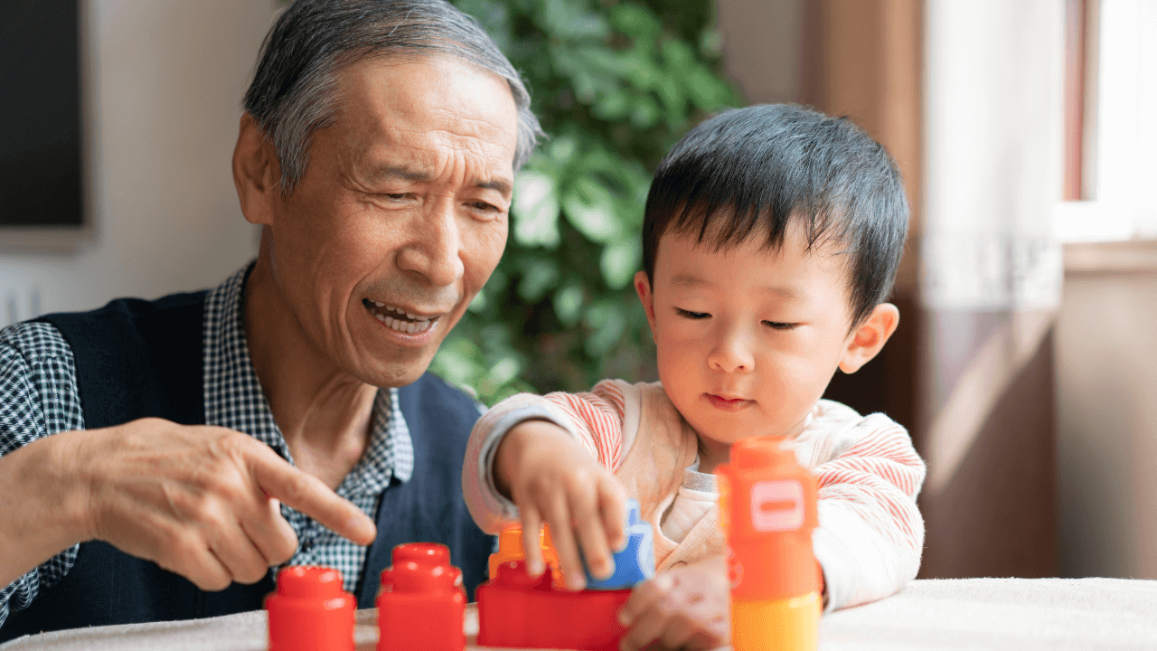 A grandfather and child playing together