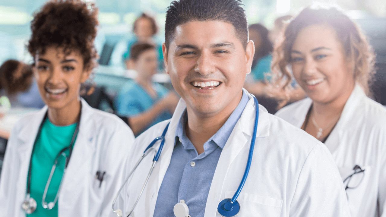 3 physician trainees smiling