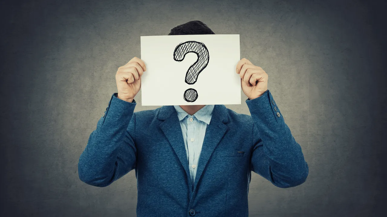 A Man holding a question