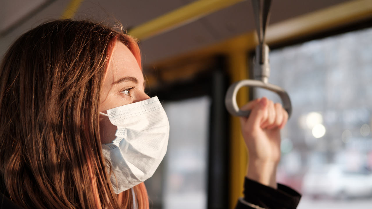 A woman wearing a mask while on public transportation