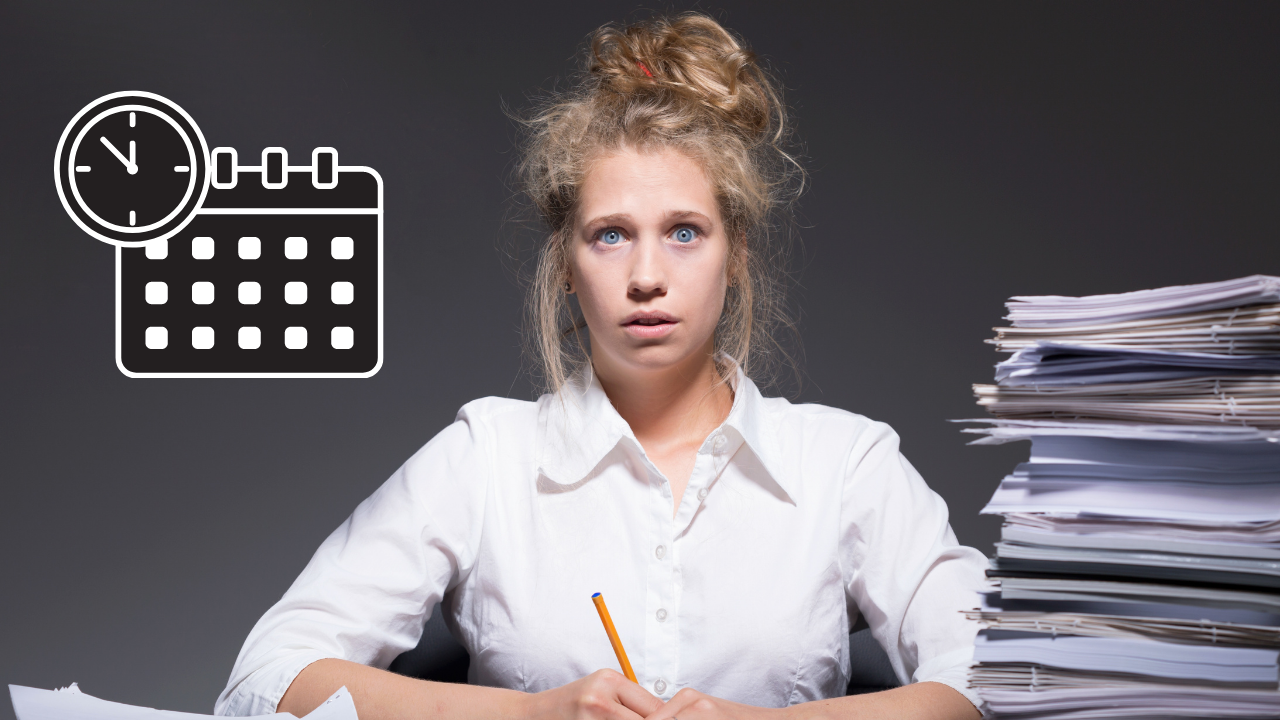 A woman sitting at a desk full of backlog