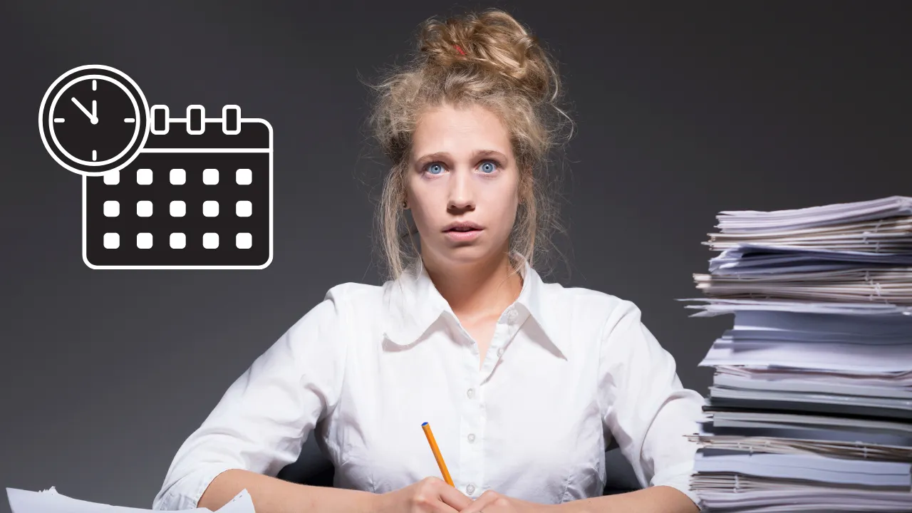 A woman sitting at a desk full of backlog