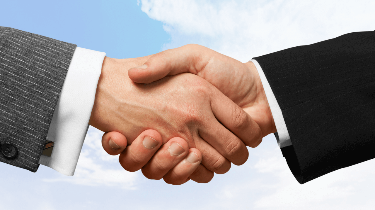 Two individuals shaking hands | Scott Legal, P.C. Two individuals shaking hands