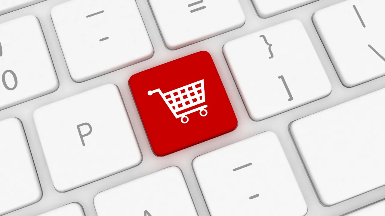E commerce depicted as a shopping cart on a keyboard