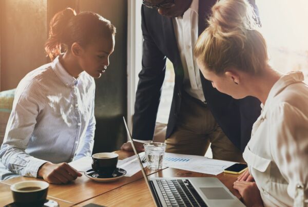 Three team members working together