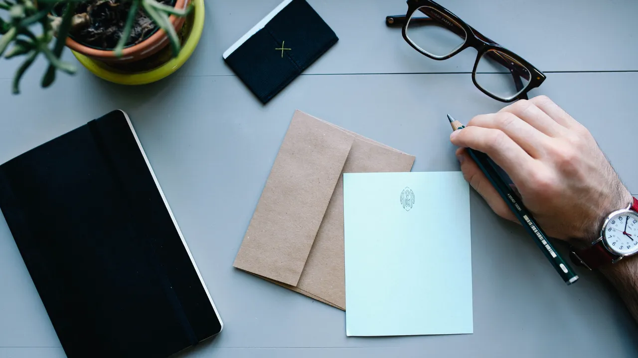 A business man writing a letter on his desk