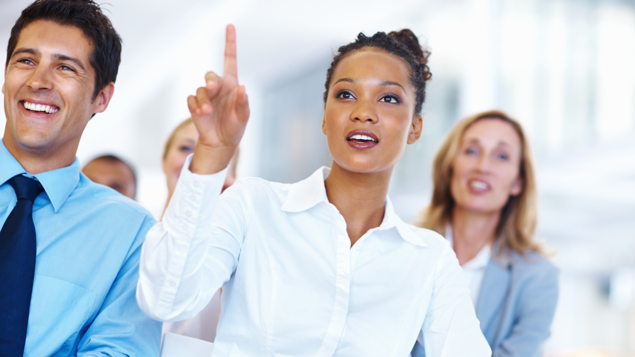 A woman asking a question during a work meeting