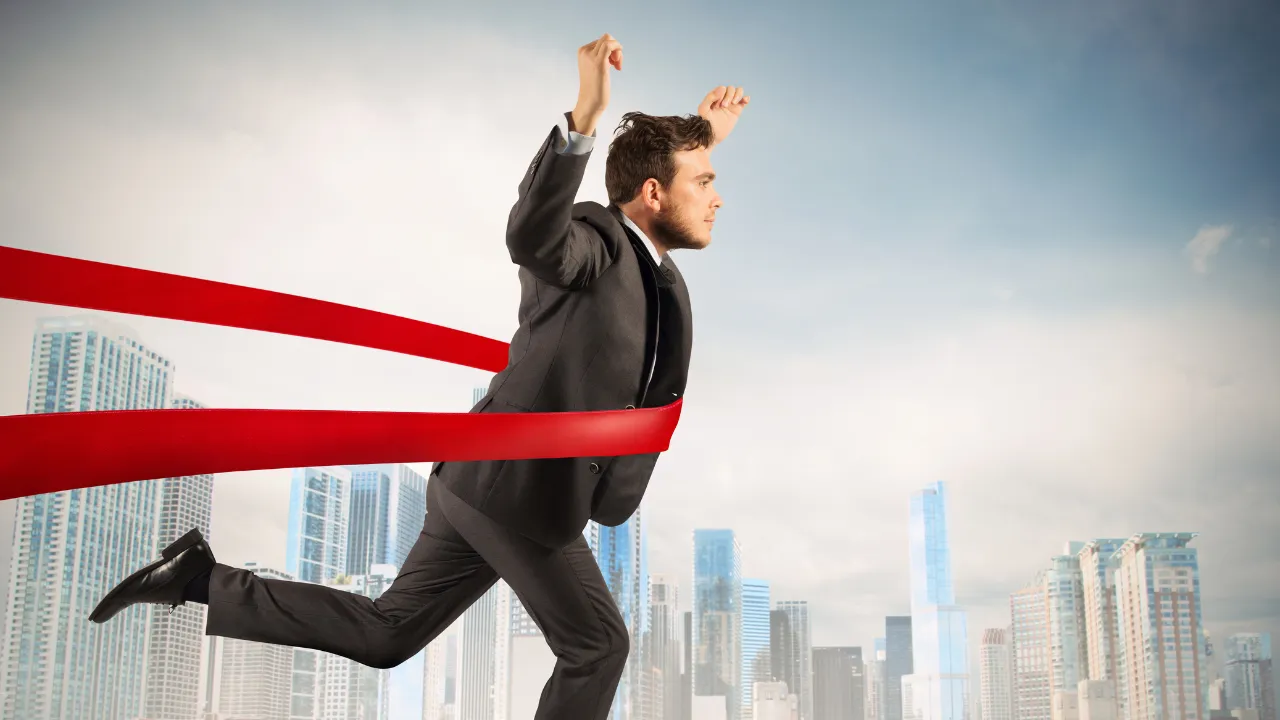 A man celebrating finishing and winning a race