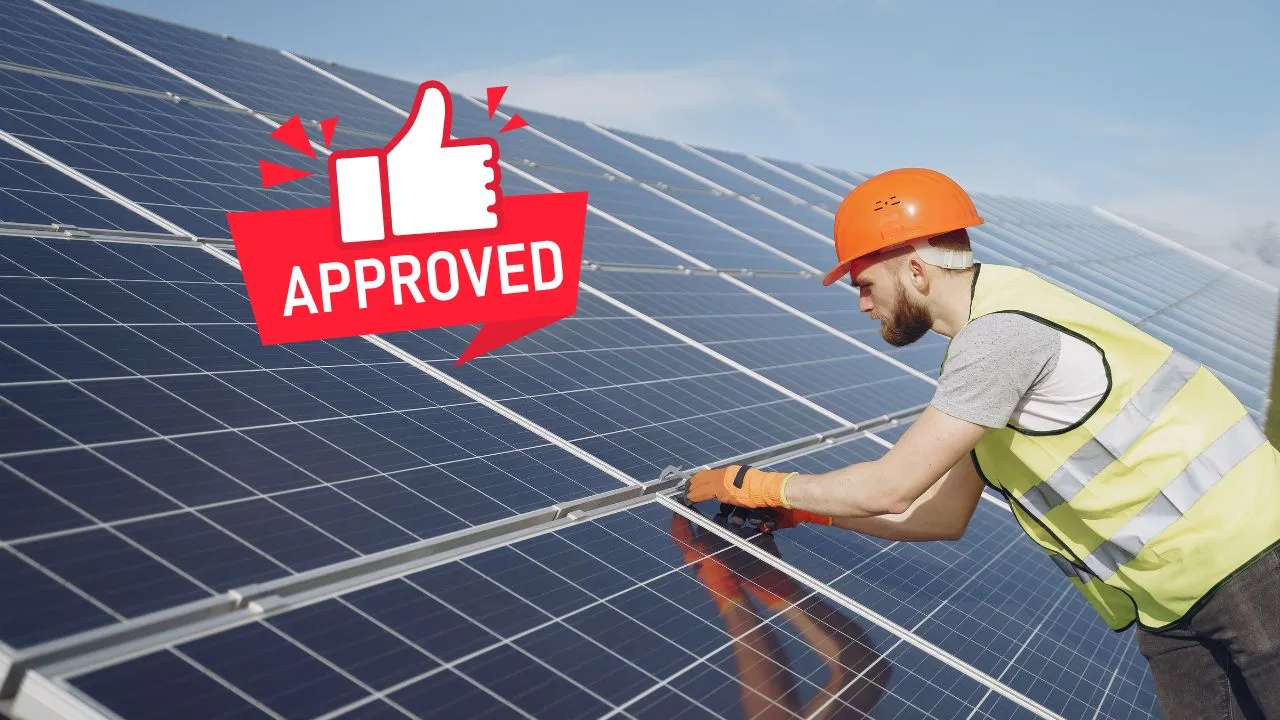 a man installing solar panels to a house with an approved sign next to him