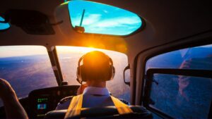 A pilot flying at sunset