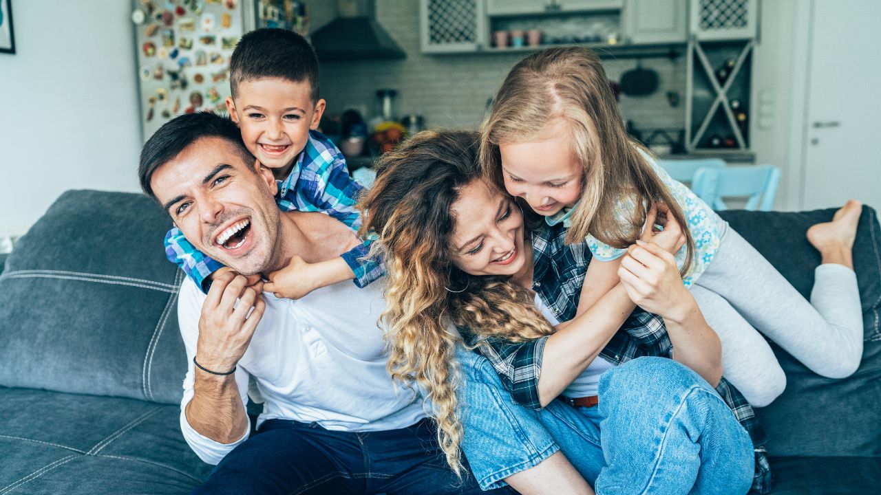 A happy family enjoying themselves on their couch