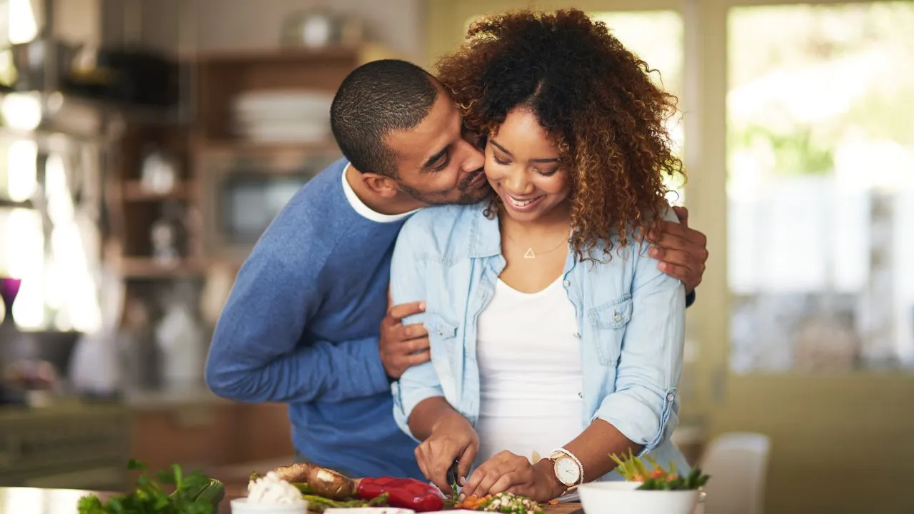 A couple cooking dinner together