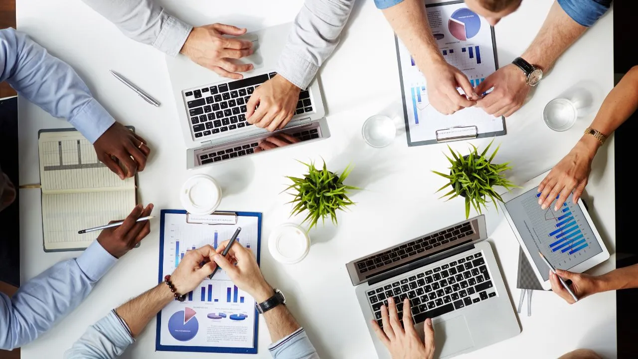 Office team working with their laptops and tablets out