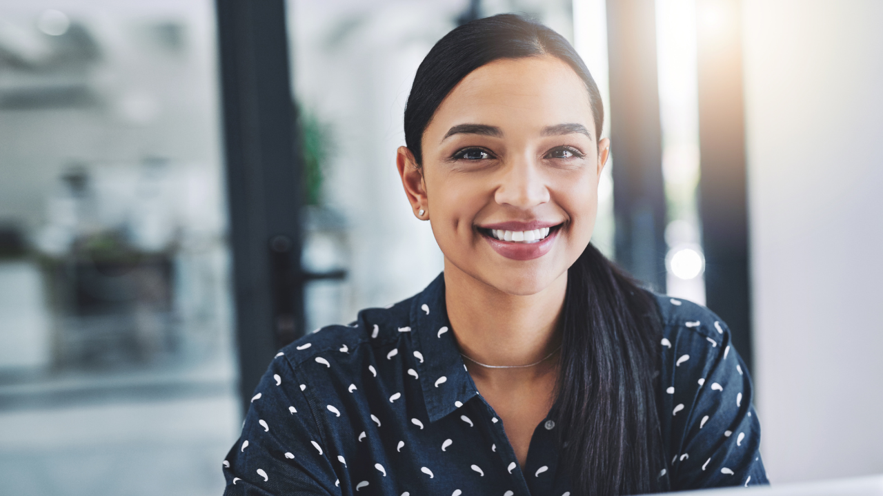 A woman smiling at her most recent approval