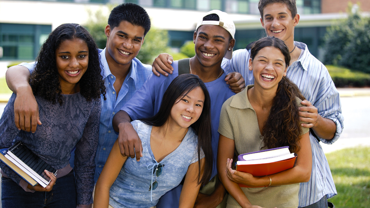 A group of teens laughing at school