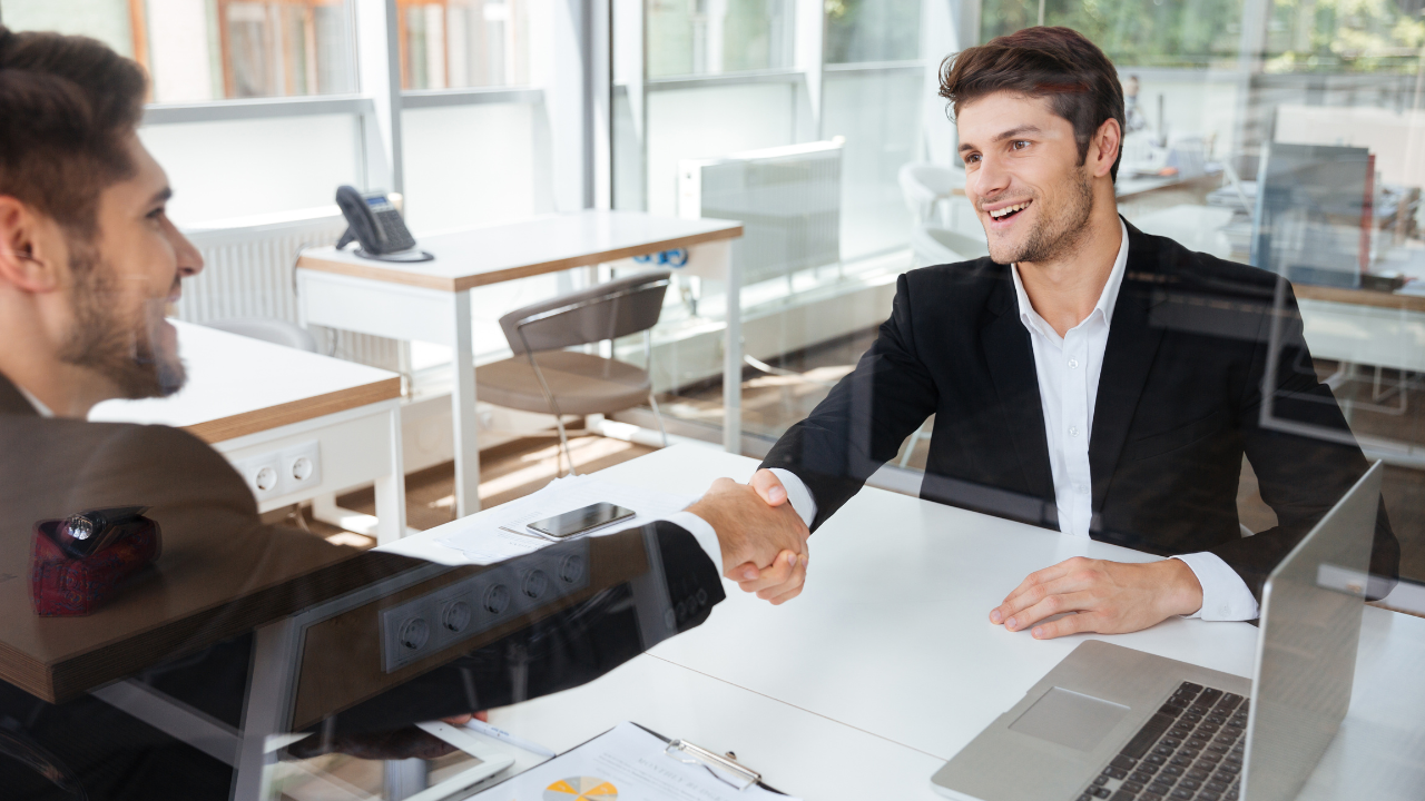 Two men meeting in an office, shaking hands