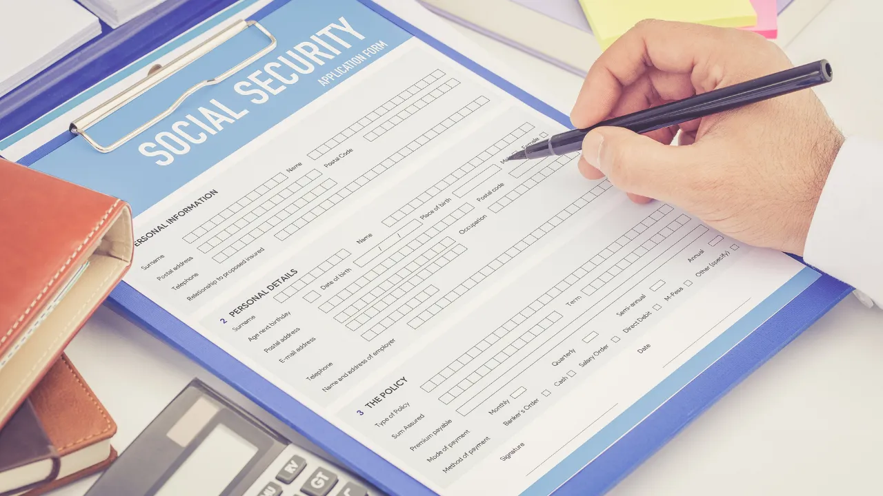 A man filling out a social security application form